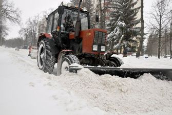В Киеве на Оболони снегоуборочная машина снесла автомобилю крышу